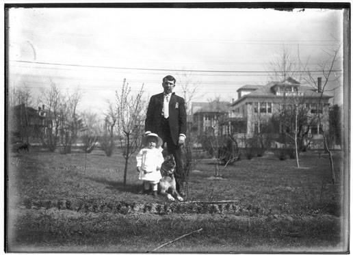 Joseph L. Hayden and son Joseph Hayden, along with the family pet, stand in the front yard on Steinmetz's Wendell Avenue home for a photograph